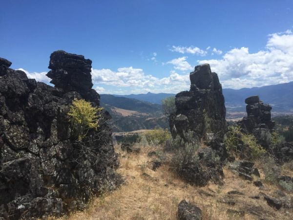 rugged mountaintop rock formations against blue sky