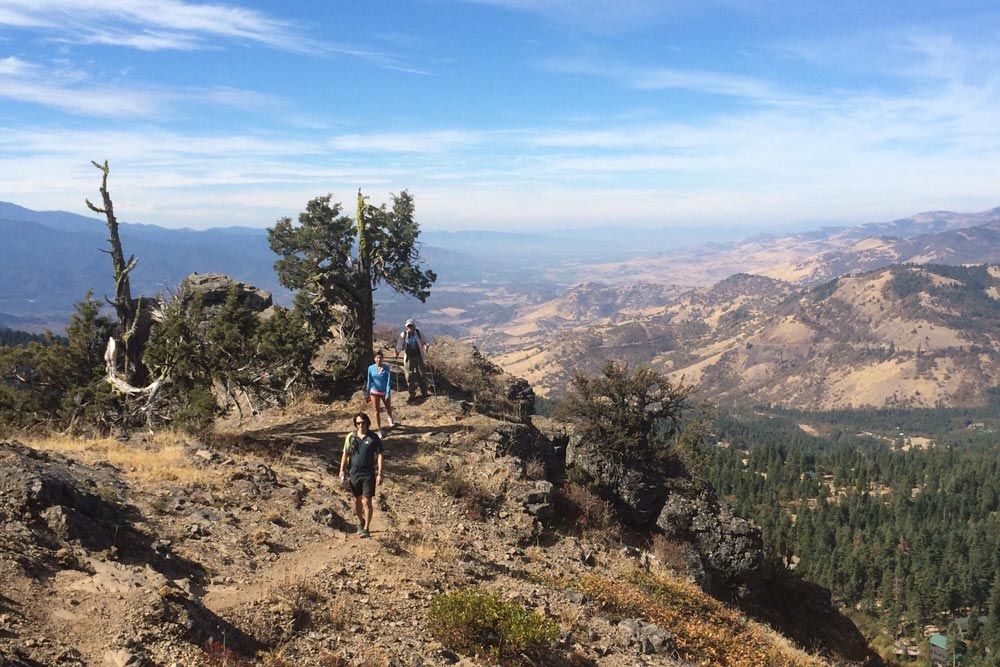 hikers at Hobart Bluff with view of the Rogue Valley